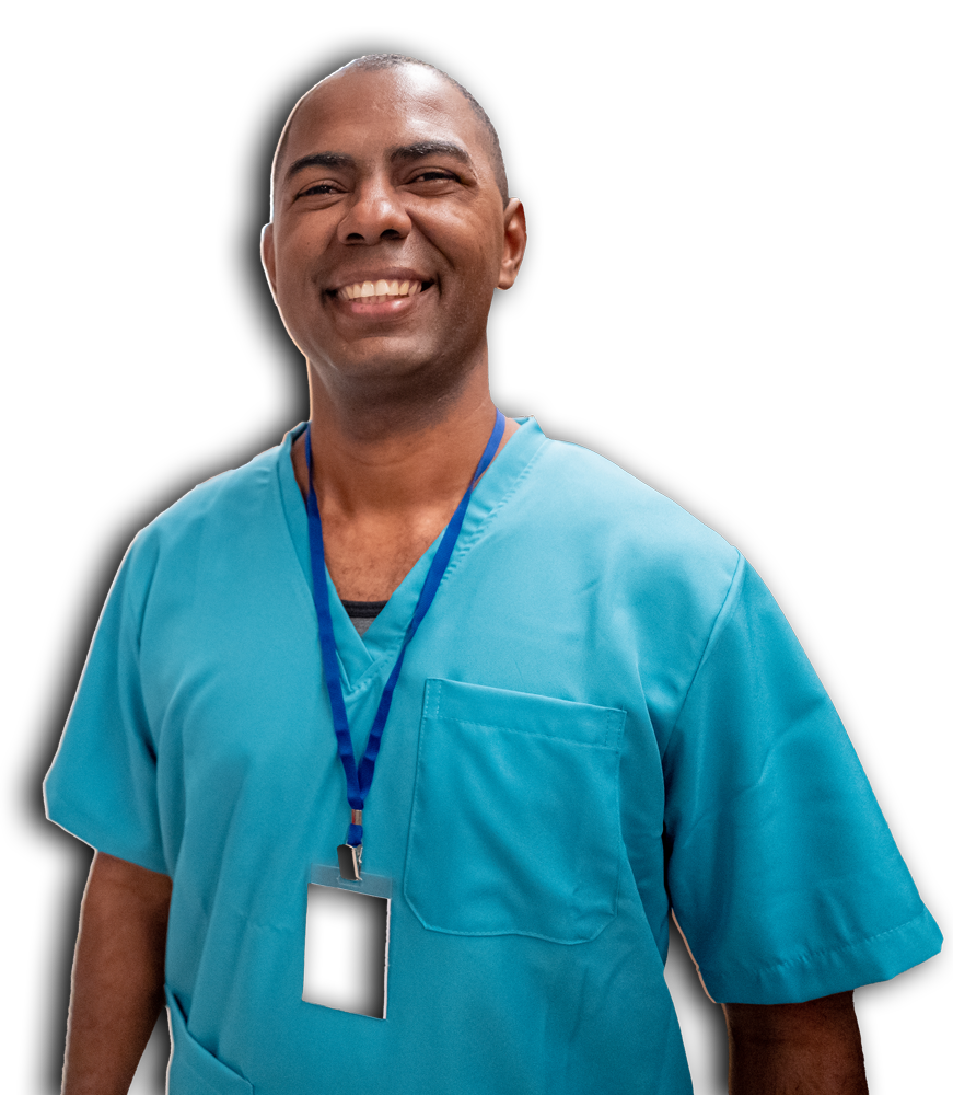 A smiling male doctor wearing a blue scrub suit, exuding professionalism and warmth in a clinical setting.