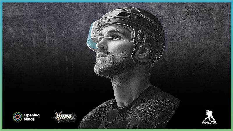 A man is wearing a hockey helmet and goggles, prepared for an intense game on the ice.