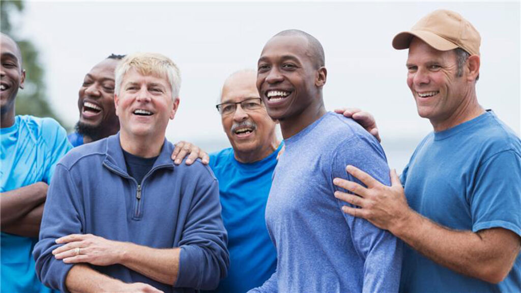 group of men smiling and posing together, showcasing camaraderie and friendship.