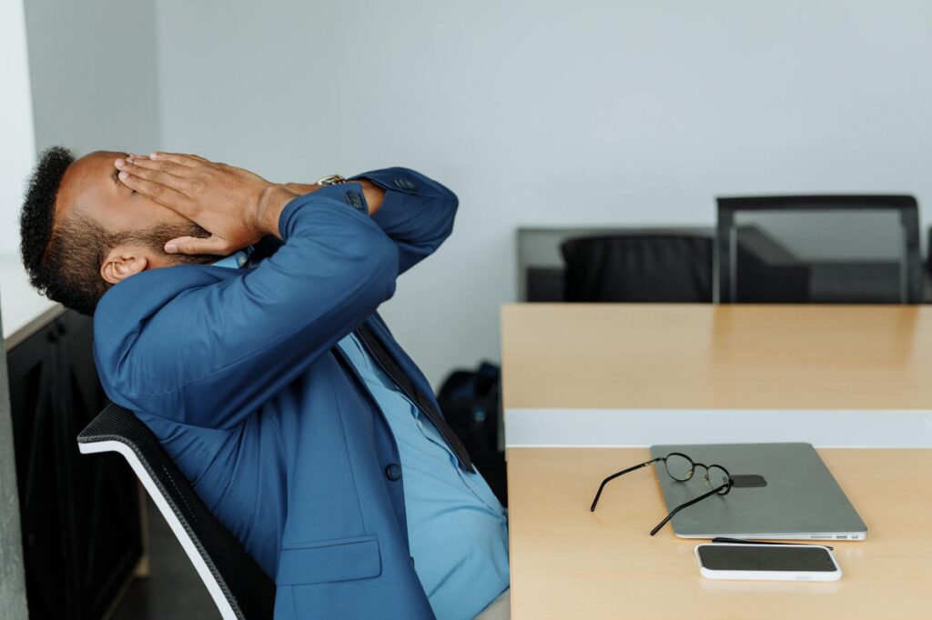 Employee experiencing workplace stress at desk in Canadian office