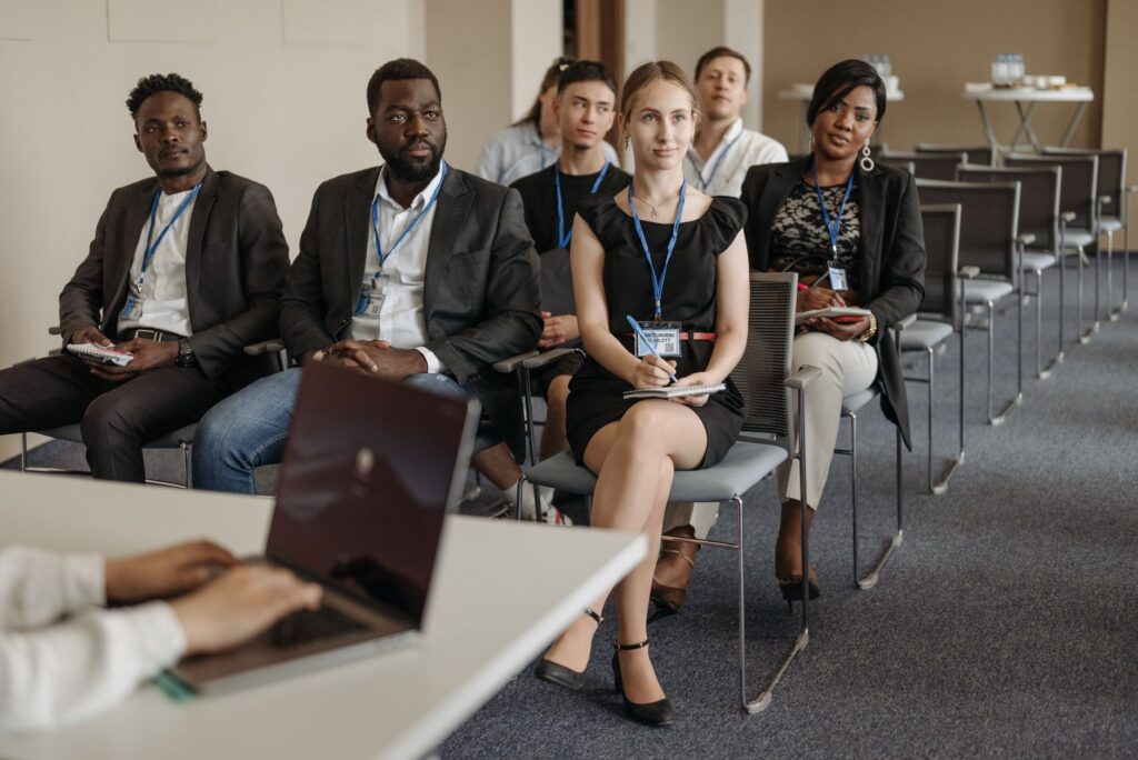 Diverse group of business professionals attentively attending a training session on psychological health and safety