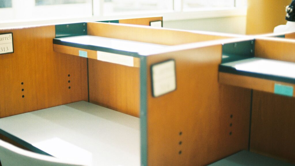 Empty office desk by a window, illustrating an employee absence at work