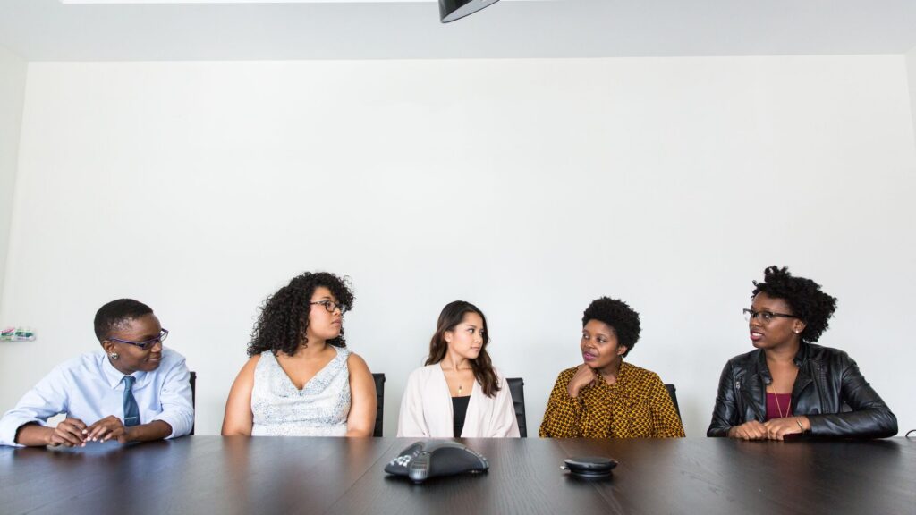 A diverse team of professionals collaborating in an office meeting, illustrating mental health at work