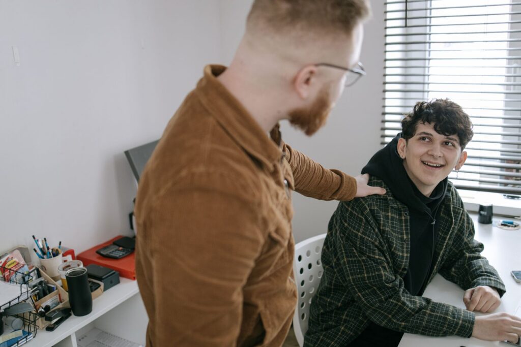 Two colleagues having a supportive conversation at work about mental health