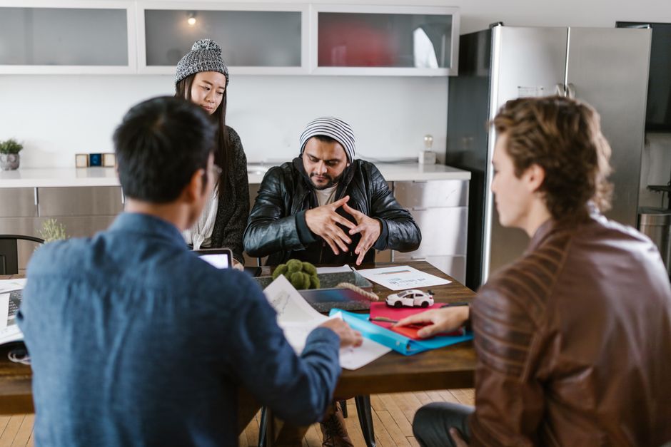 A group of diverse colleagues in a modern office setting engaged in a brainstorming session.