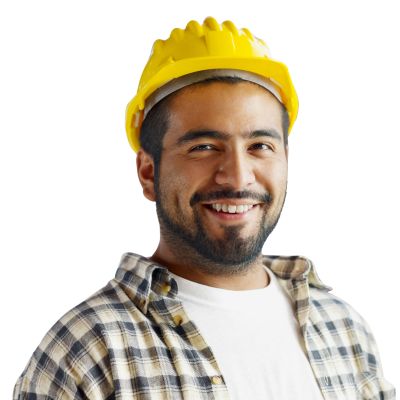 A man wearing an orange vest and glasses holds a hard hat, standing in a construction environment.